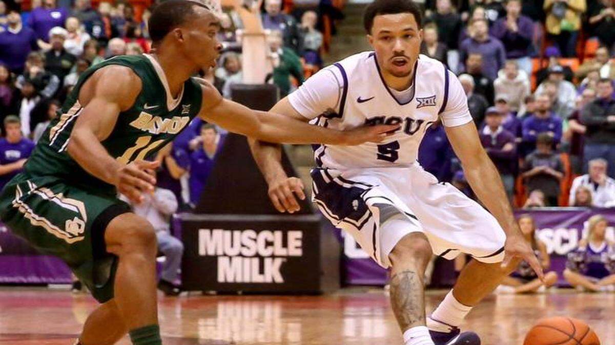 
TCU guard Kyan Anderson (5) tries to get past Baylor guard Lester Medford (11) during Saturday’s game in Fort Worth. The Horned Frogs fell to 0-3 in the Big 12 after a 13-0 nonconference start. 
