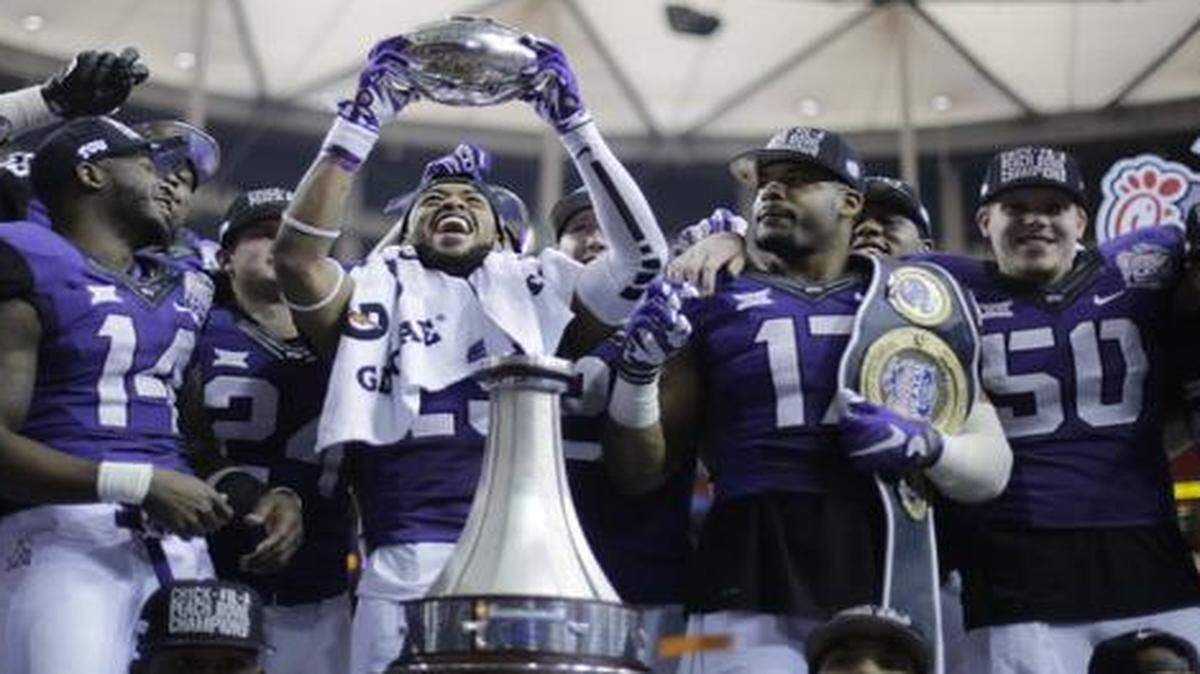 
TCU players enjoy the spoils of winning on stage with the Peach Bowl trophy after beating Mississippi 42-3 on Wednesday.
