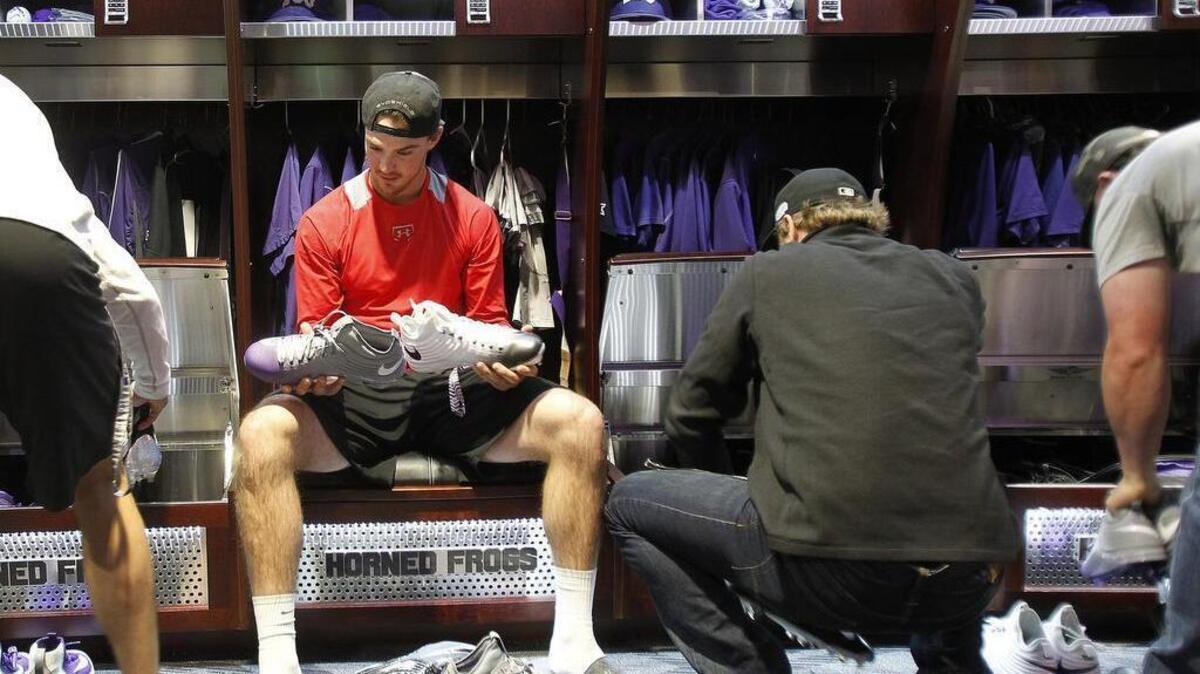 Ryan Johnson checks out his new shoes during the unveiling of TCU’s new locker room.