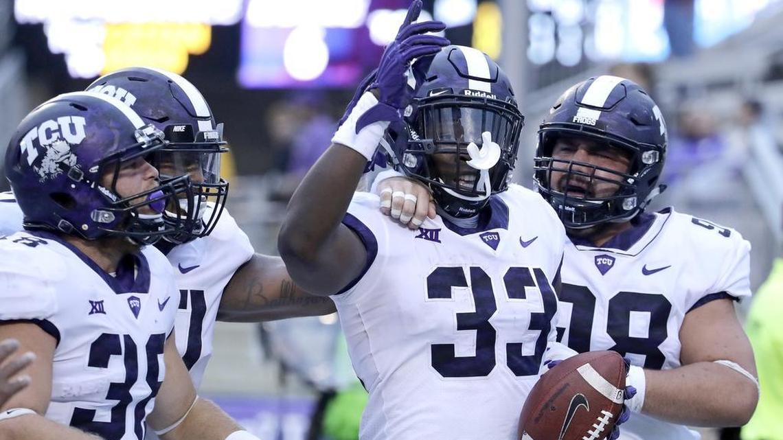 TCU running back Sewo Olonilua celebrates with teammates after one of his two touchdowns against K-State on Saturday at Bill Snyder Family Stadium.