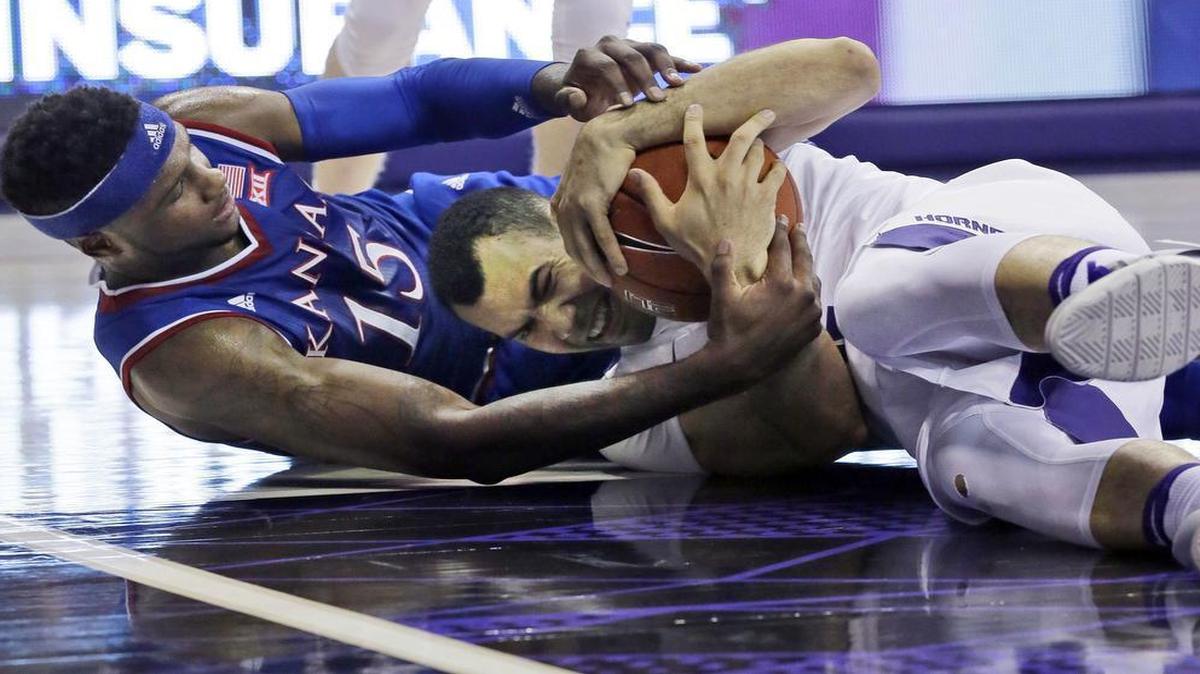 TCU guard Michael Williams and Kansas forward Carlton Bragg Jr. scramble for a loose ball in Friday’s game in Fort Worth.