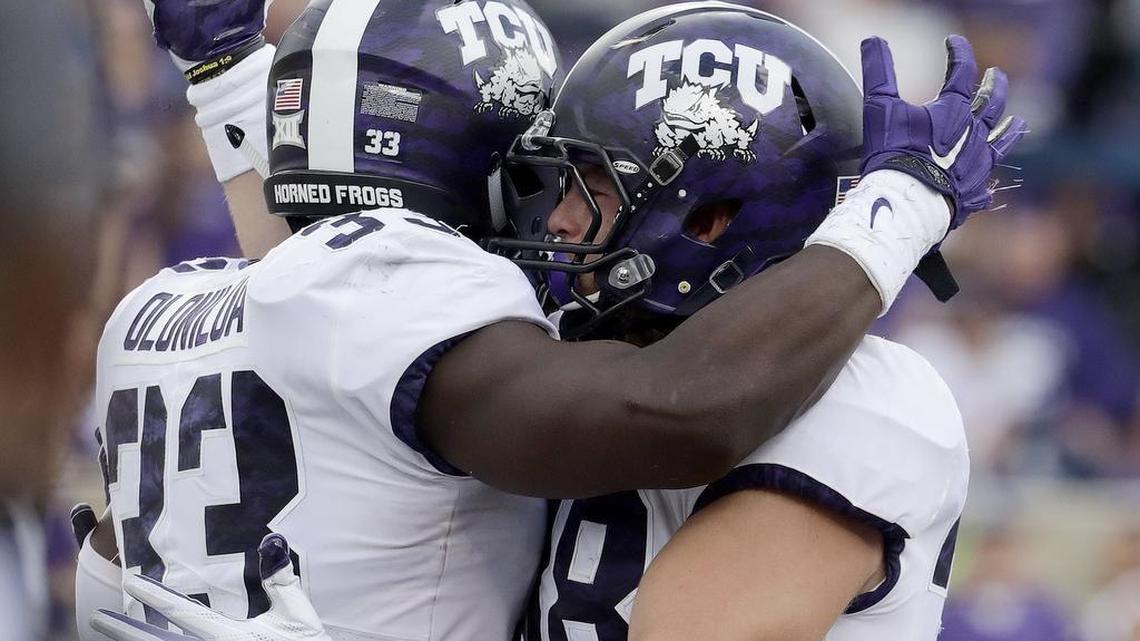 TCU running back Sewo Olonilua (left) gets congratulations from tight end Daythan Davis following one of his two touchdowns against Kansas State on Saturday.
