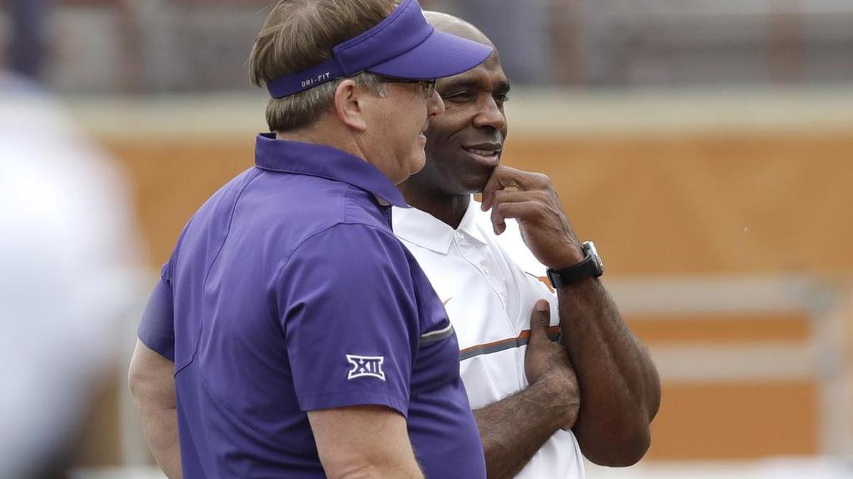 TCU football coach Gary Patterson, left, and Texas coach Charlie Strong, right, talk before Saturday’s game in Austin. TCU leads at the half, 7-6.