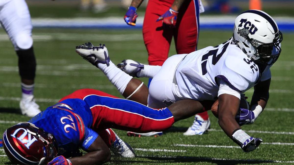 TCU linebacker Travin Howard goes to the ground after being tackled following an interception against Kansas on Oct. 8 in Lawrence, Kan.