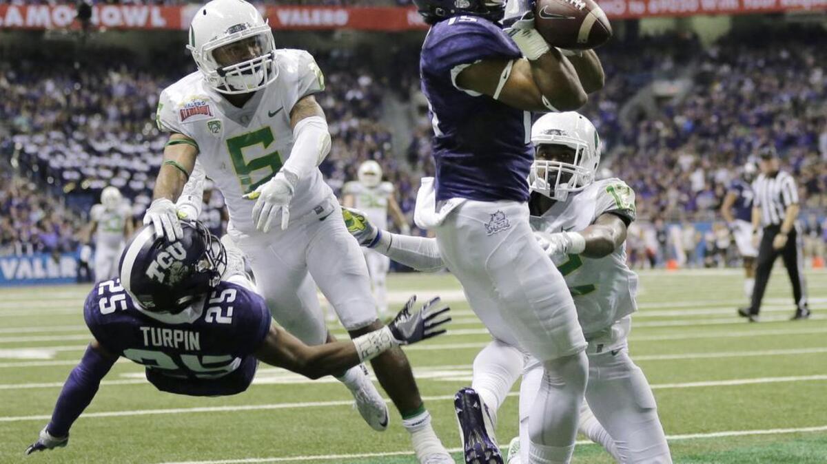 TCU receiver Jaelan Austin brings in a 26-yard touchdown pass during the Alamo Bowl against Oregon. The fourth-down strike in the third quarter from Bram Kohlhausen was the first touchdown in TCU’s rally for a 47-41 victory in three overtimes.