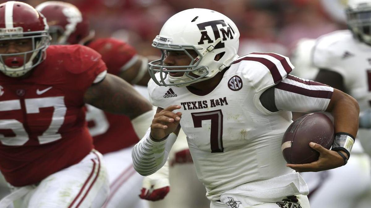 
Former Southlake Carroll quarterback Kenny Hill scrambles away from pressure in a Texas A&M game at Alabama in October 2014. Hill said at a high school baseball playoff game he will be ready to enroll at TCU in June.
