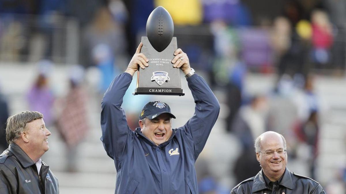 Sonny Dykes holds the championship trophy after his Cal team defeated Air Force 55-36 in the Lockheed Martin Armed Forces Bowl on Dec. 29, 2015, at Amon G. Carter Stadium.