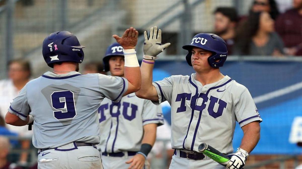 TCU’s Evan Skoug high-fives Josh Watson as he crosses home plate for a run scored against Texas A&M during the first inning.