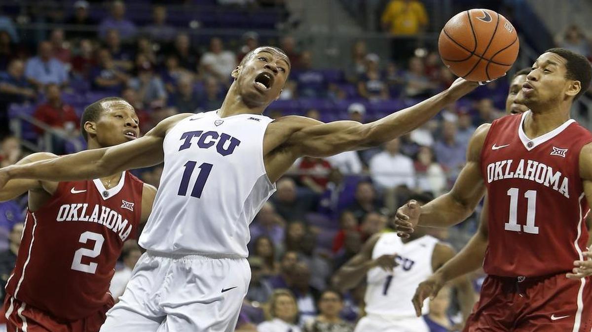 TCU guard Brandon Parrish tries to maintain control of the ball as he’s fouled by Oklahoma’s Isaiah Cousins during second-half action. Parrish finished with a season-high 20 points for the Horned Frogs.