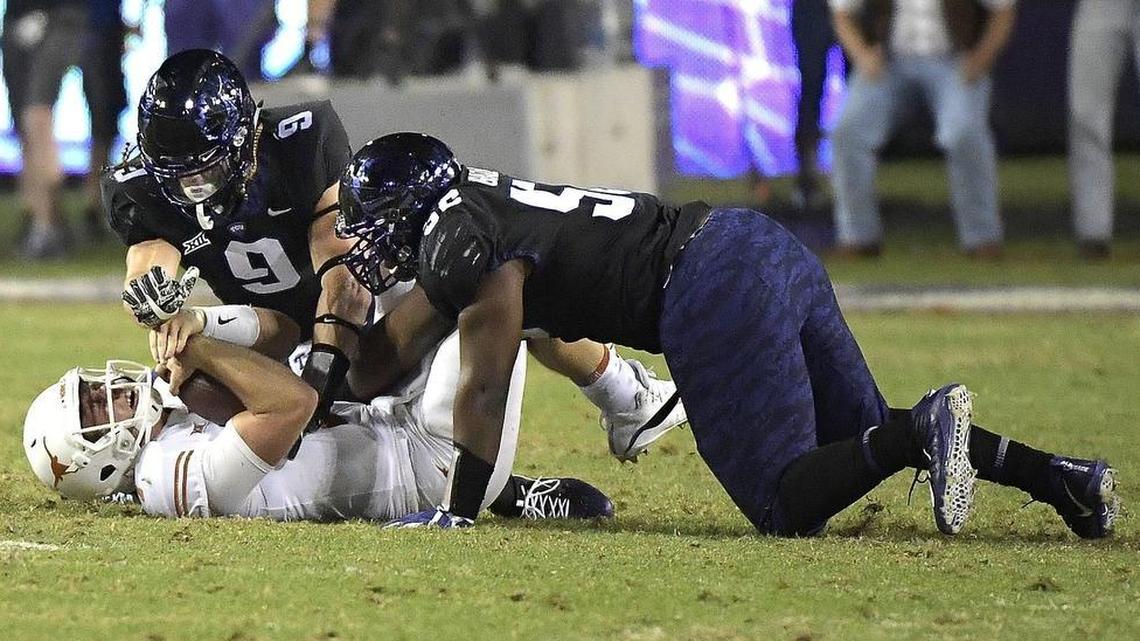 TCU defenders Chris Bradley and Mat Boesen bring down Texas quarterback Shane Buechele on a sack in the second quarter of last week’s game at Amon G. Carter Stadium. It was one of seven sacks for TCU, now the nation’s No. 6 defense.