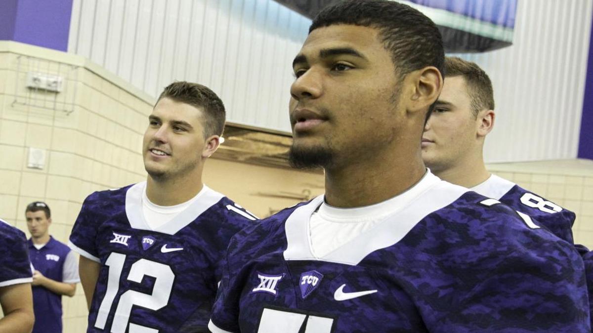 TCU quarterbacks Foster Sawyer (left) and Kenny Hill wait for their turn in front of the camera at Photo Day on Aug. 7 at the Sam Baugh Indoor Practice facility.