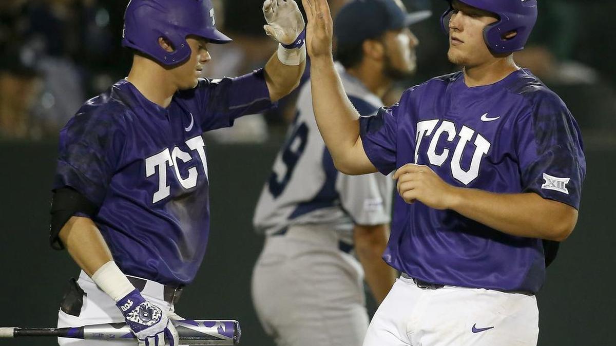 TCU’s Connor Wanhanen, left, congratulates Luken Baker in a game in February. On Sunday, Wanhanen had an RBI single and double, going 3 for 5, and Baker had two hits and two runs scored in a 5-4 loss to West Virginia.