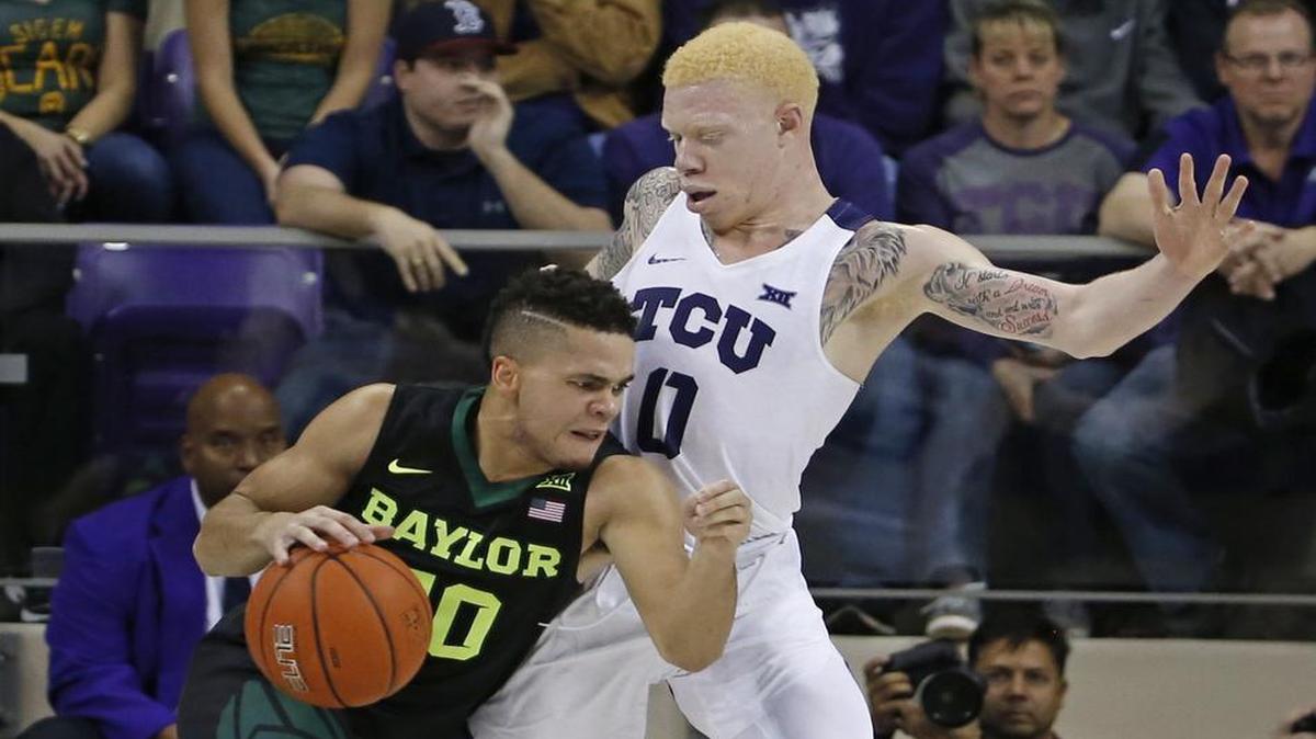 Jaylen Fisher, right, and TCU hung close to Manu Lecomte and Baylor most of the game Saturday before fading down the stretch.