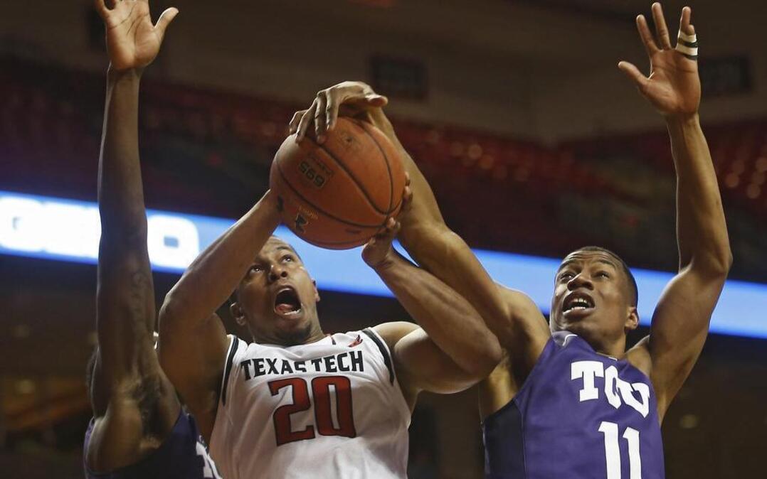 TCU’s Brandon Parrish, right, blocks the shot of Texas Tech’s Toddrick Gotcher on a play under the basket in a Feb. 23 game in Lubbock. Texas Tech rallied from a 12-point halftime deficit to sweep the Horned Frogs en route to a No. 7 seed in the Big 12 tournament. TCU is the No. 10 seed.