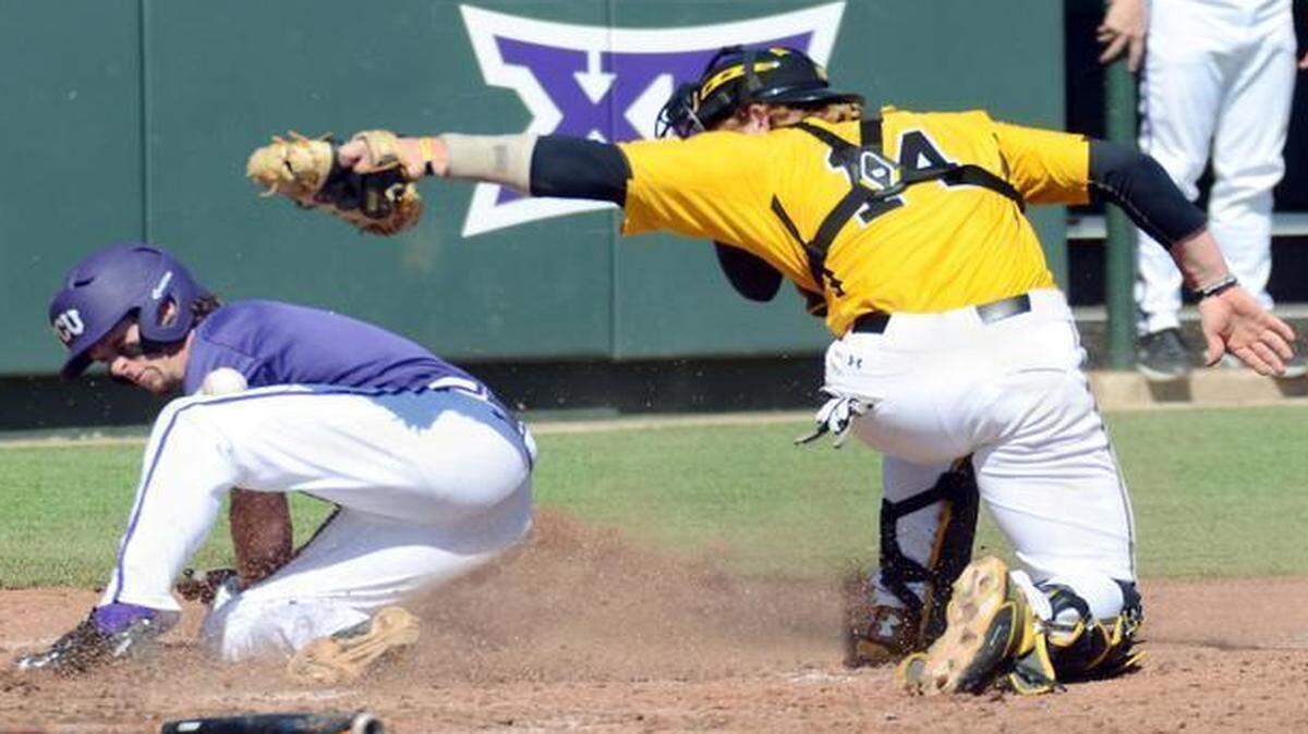 
TCU’s Cody Jones slides home safely to give the Horned Frogs a 4-2 lead in the fifth inning Saturday as Wichita State catcher Gunnar Troutwine loses the ball while trying to apply the tag.
