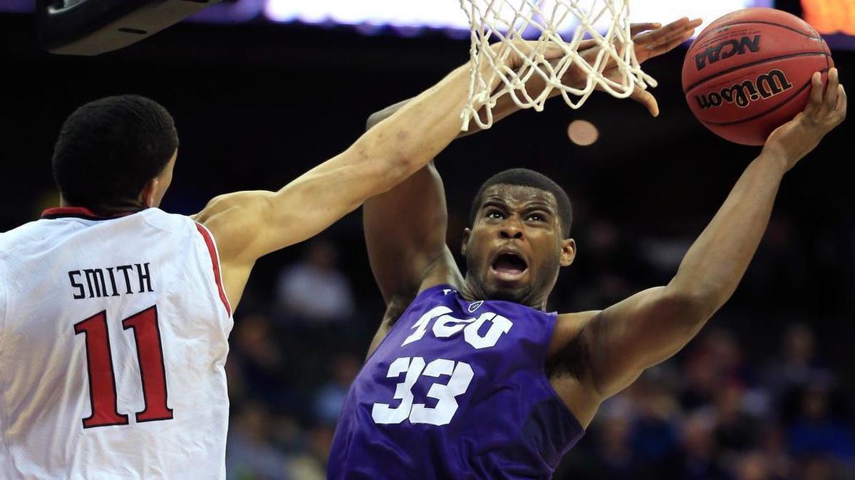 TCU forward Chris Washburn (33) shoots while covered by Texas Tech forward Zach Smith (11) during the second half their first-round game in the Big 12 tournament in Kansas City, Mo. TCU defeated Texas Tech 67-62.