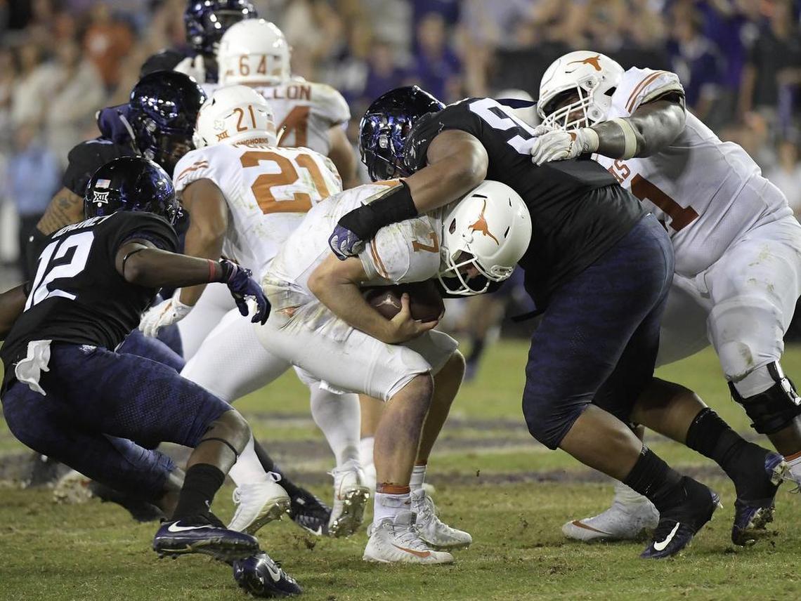 TCU defensive tackle Ross Blacklock (right) brings down Texas quarterback Shane Buechele for a sack in the fourth quarter of a Nov. 4 Big 12 game at Amon G. Carter Stadium. It was one of seven sacks in the game by the Horned Frogs and two this season by Blacklock, named to the Football Writers Association of America Freshman All-America Team.