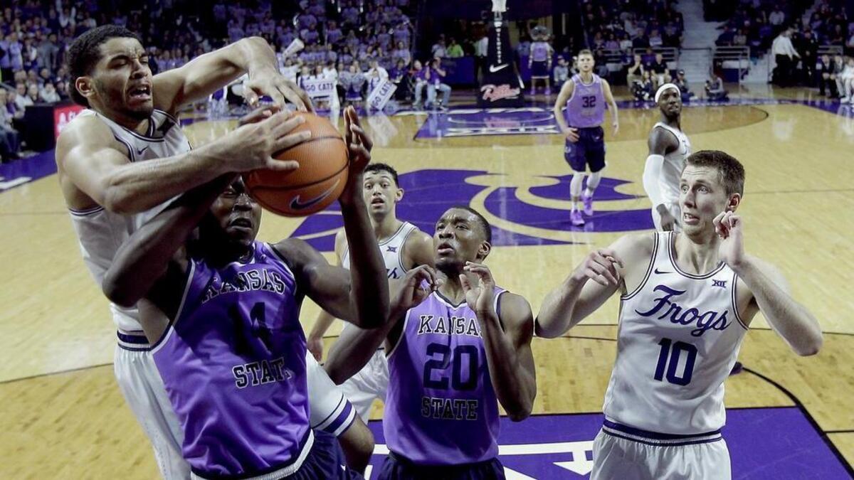 TCU’s Kenrich Williams, left, battles Kansas State’s Makol Mawien for a rebound during the Wildcats’ 73-68 win at Bramlage Coliseum on Saturday.