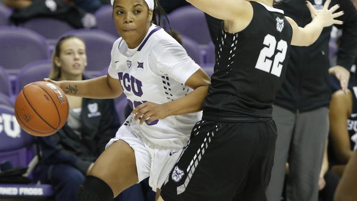 TCU guard AJ Alix (23) turns the corner in front of Butler guard Alexa Bailey (22) during a game Nov. 30.