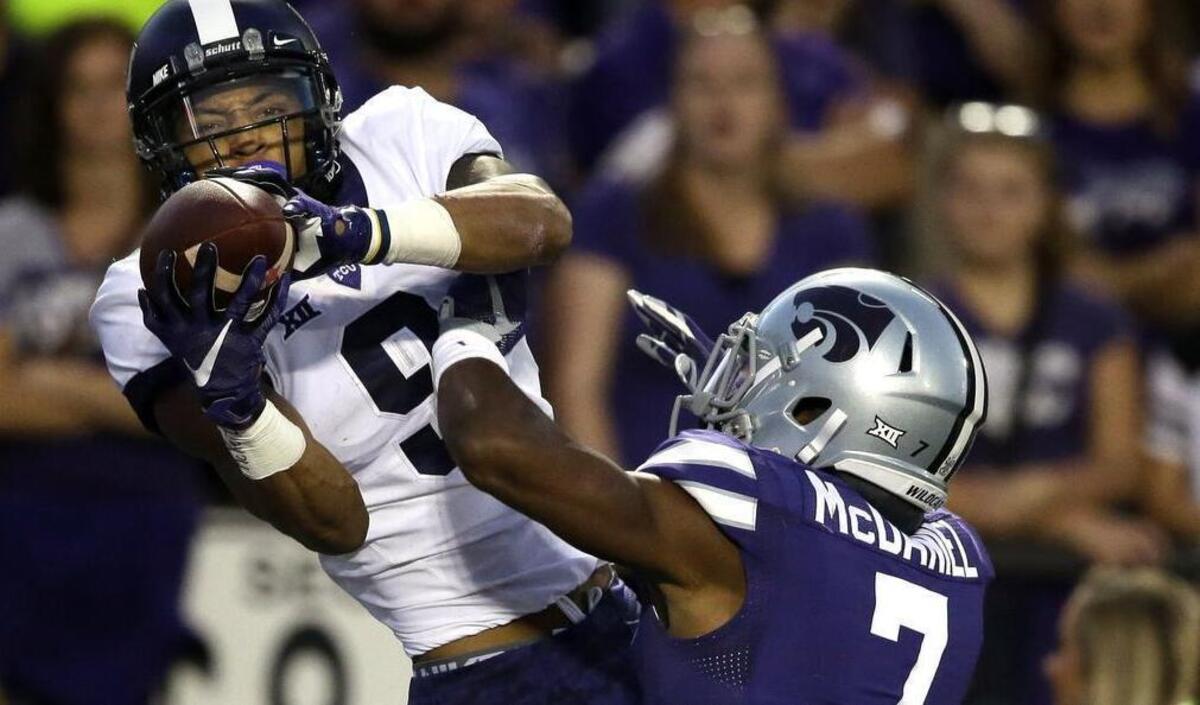 
TCU wide receiver Josh Doctson catches a touchdown pass while covered by Kansas State defensive back Danzel McDaniel.
