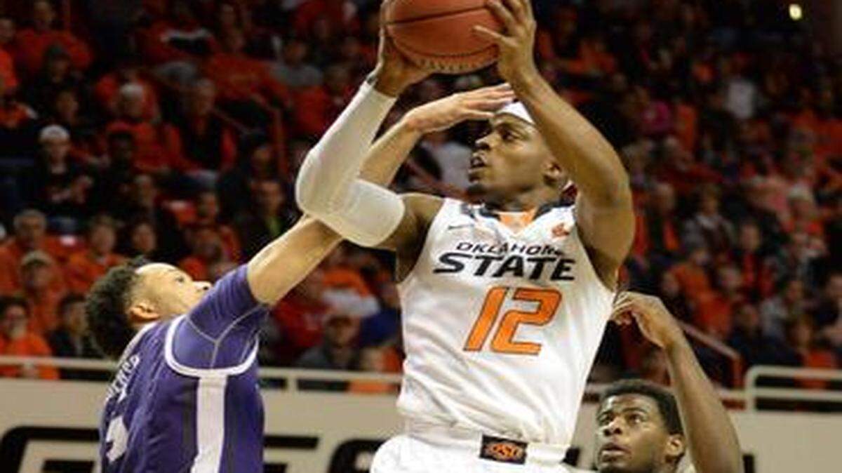 
Oklahoma State senior guard Anthony Hickey, center, hit 4 of 4 3-pointers and finished with 20 points on the Cowboys’ Senior Night.


