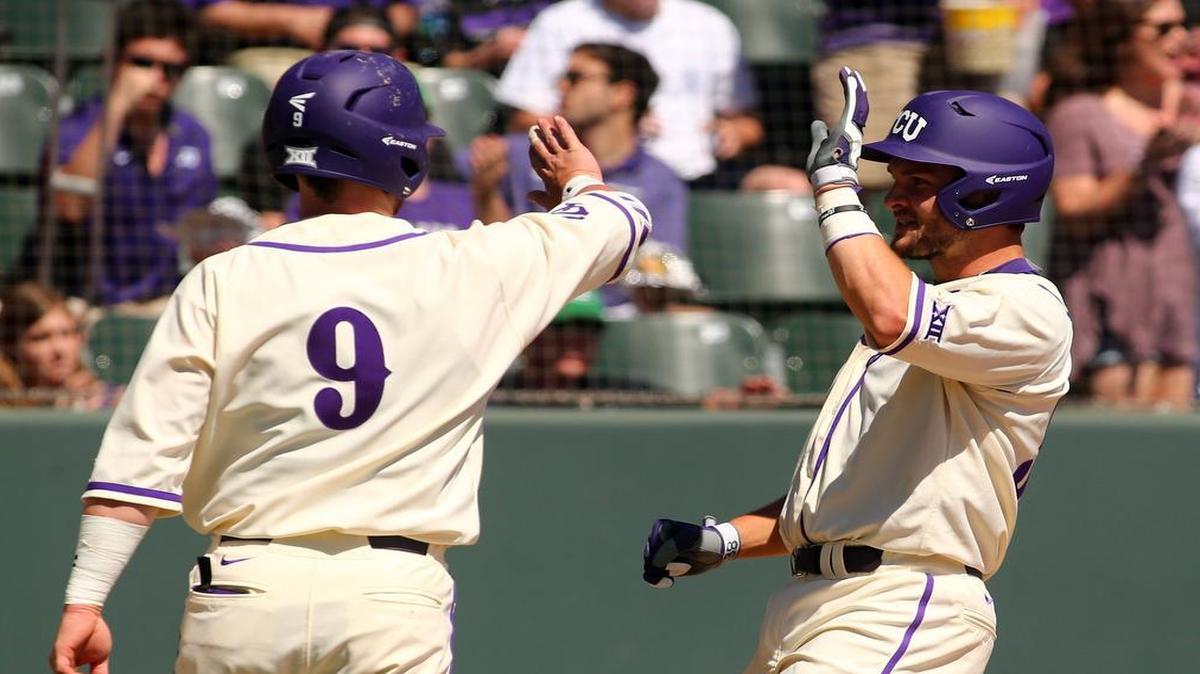 TCU’s Evan Skoug, left, high fives Zack Plunkett, who scored in the second inning on a single by Cam Warner.