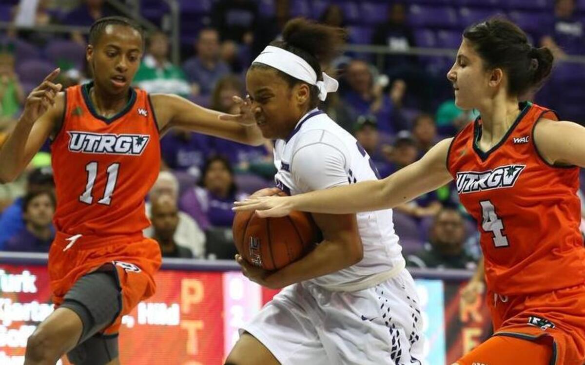 TCU guard AJ Alix tries to split UT Rio Grande Valley defenders Shawntee’ Goff, left, and Idil Turk as she drives to the basket Thursday. Alix scored 20 points to help lead TCU.