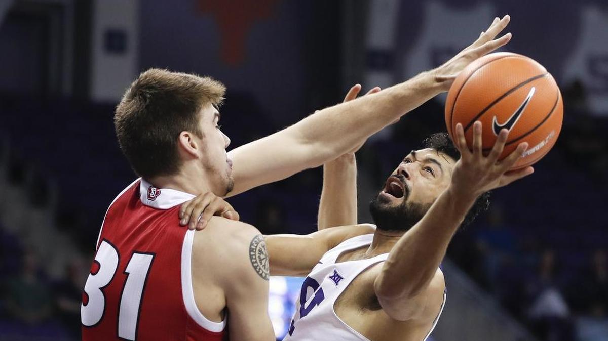 TCU guard Alex Robinson, right, scored seven points Wednesday night as the Horned Frogs slipped past South Dakota and Dan Jech 76-71.