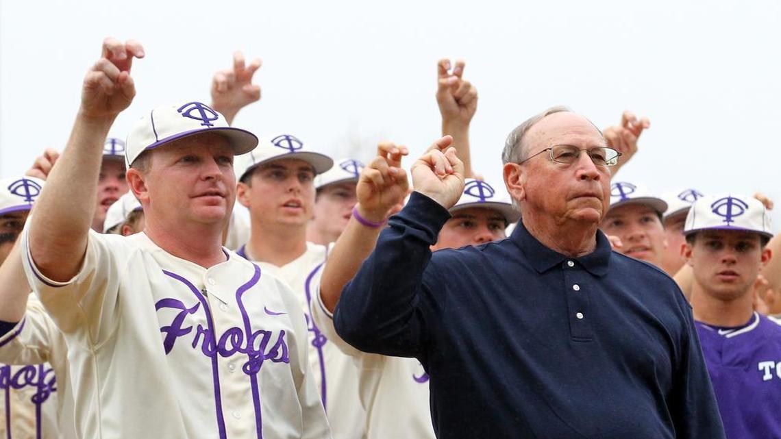 TCU coach Jim Schlossnagle and former coach Lance Brown stand for the alma mater following a 5-0 victory against Loyola Marymount on Sunday that made Schlossnagle the winningest coach at TCU, breaking Brown’s victory record.
