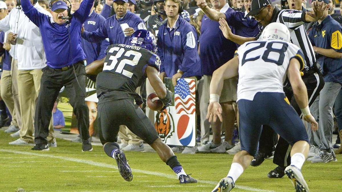 The TCU sideline celebrates as linebacker Travin Howard comes up with an interception in last season’s game against West Virginia. It was the first pickoff for the former backup safety.