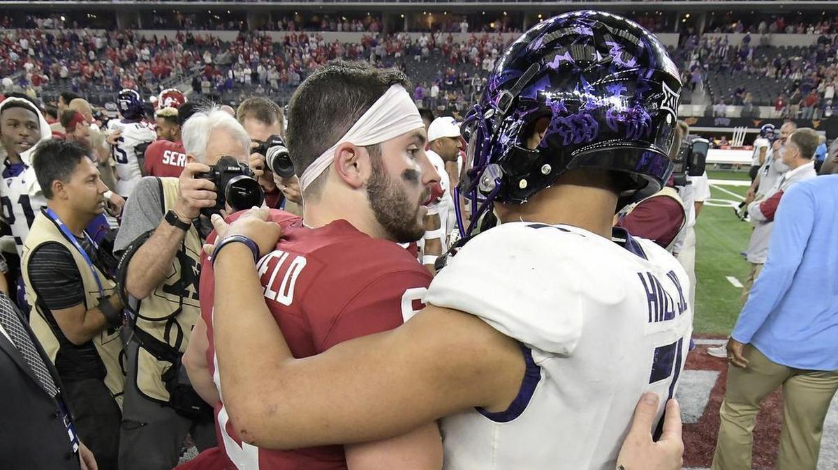 Oklahoma quarterback Baker Mayfield and TCU quarterback Kenny Hill embrace after the Big 12 championship game at AT&T Stadium on Dec. 2, won 41-17 by Mayfield’s Sooners.