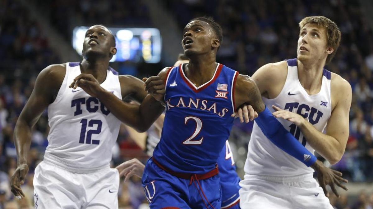 TCU forwards Kouat Noi (left) and Vladimir Brodziansky sandwich Kansas guard Lagerald Vick while waiting for a rebound during Saturday’s game at Schollmaier Arena won by Kansas 88-84.