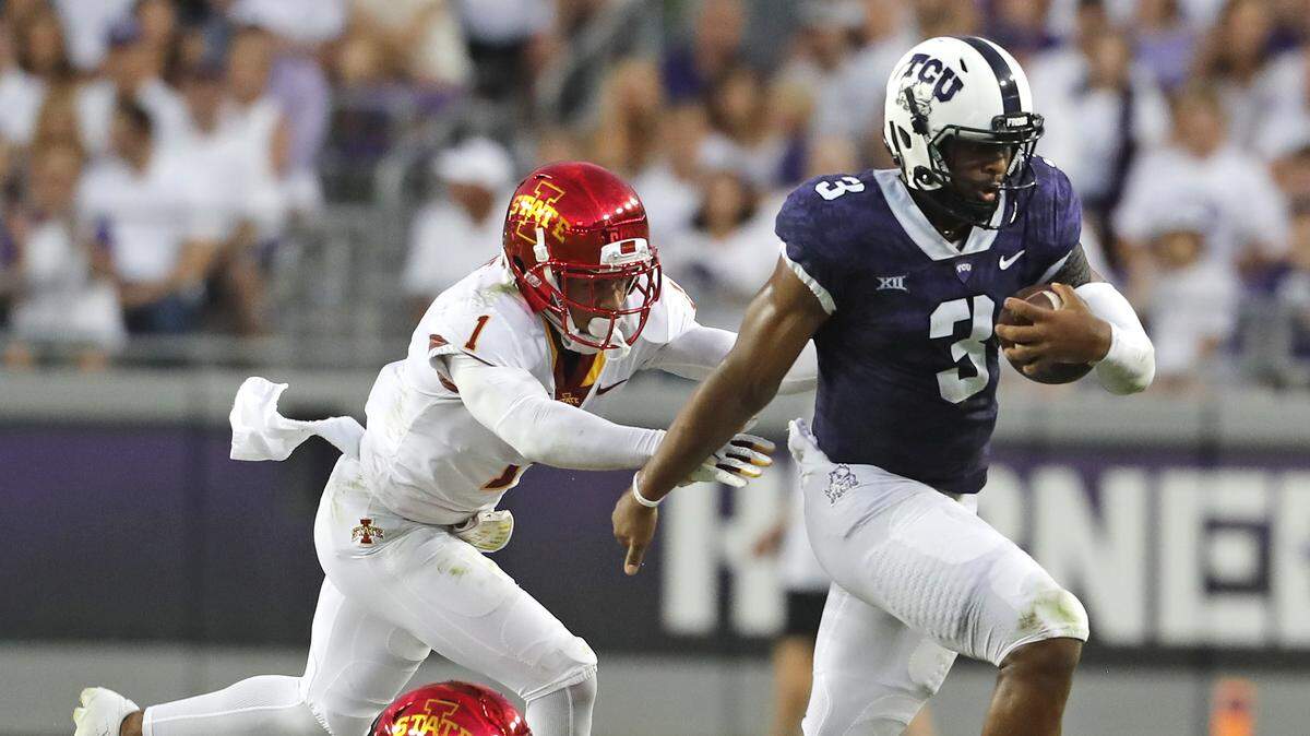 TCU quarterback Shawn Robinson (3) escapes the defense of Iowa State defensive back D’Andre Payne (1) and linebacker Reggan Northrup (9) in the first half of a NCAA college football game in Fort Worth, Texas, Saturday, Sept. 29, 2018. (Bob Booth /Star-Telegram via AP)