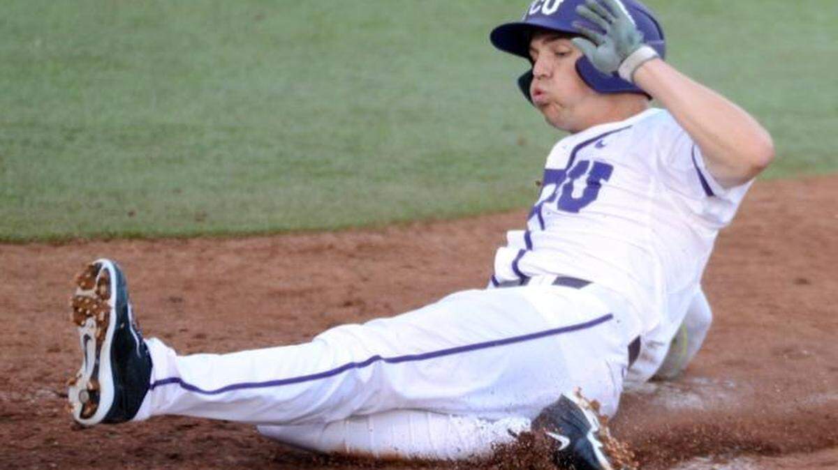 
TCU’s Derek Odell slides home with the tying run in the third inning against Dallas Baptist on Tuesday. Odell had two hits in the Horned Frogs’ 6-2 victory.
