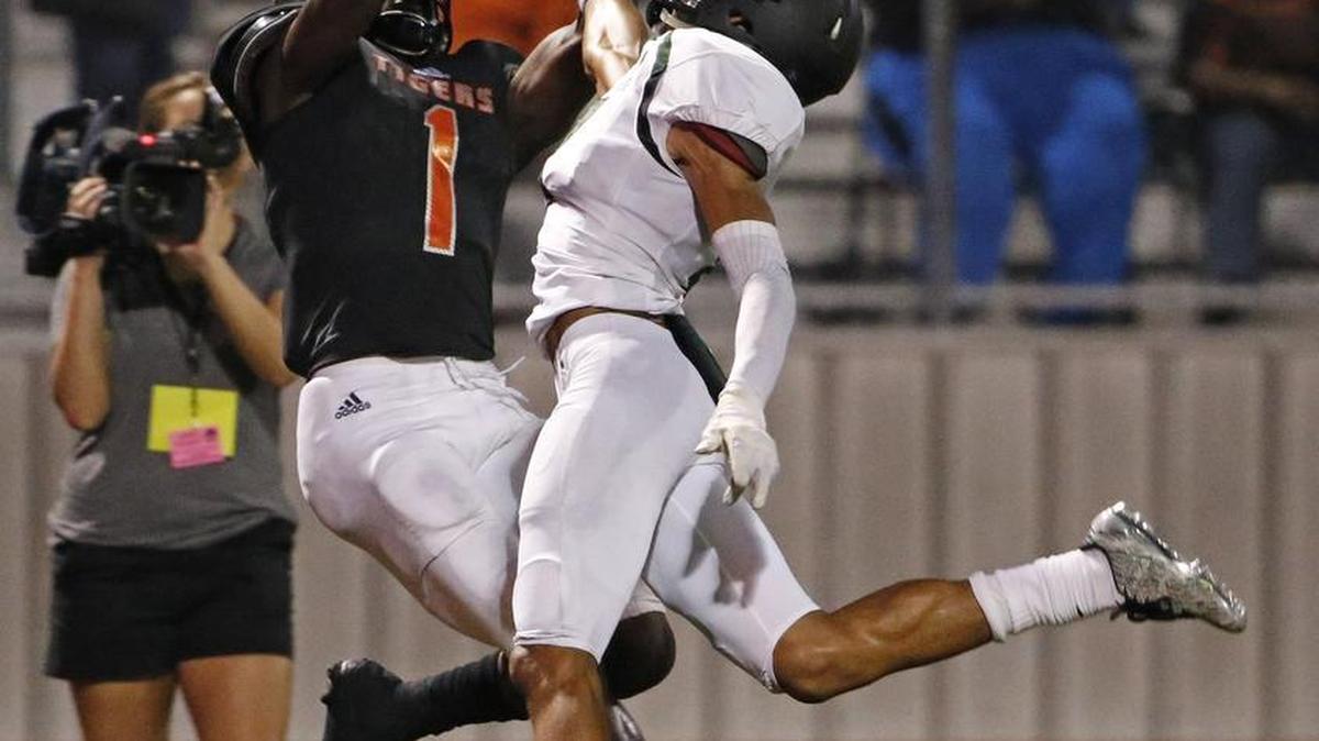 Lancaster wide receiver Omar Manning (1) hauls in a pass for a second-quarter touchdown against the tight coverage of Mansfield Lake Ridge’s Terrell Fallon in a game Sept. 16, 2016. Manning has committed to attend TCU.