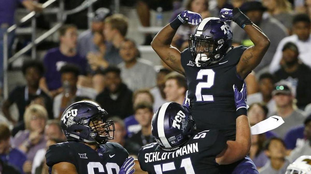 TCU receiver Taj Williams gets a celebration lift from teammate Austin Schlottman (51) after a touchdown catch against Kansas on Oct. 21 at Amon G. Carter Stadium. The Frogs’ 43-0 victory got them to 7-0 on the season before last week’s loss to Iowa State.