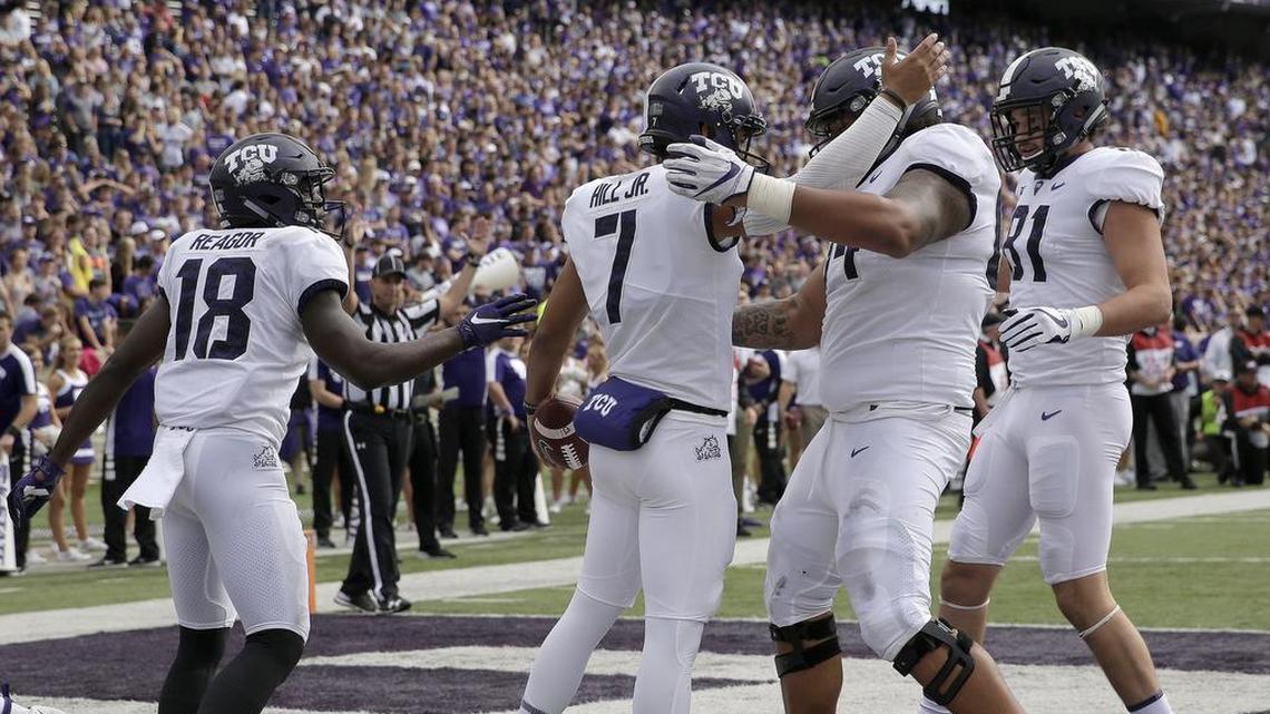TCU quarterback Kenny Hill, middle, celebrates with teammates after running for a touchdown in the first hald of the Horned Frogs’ 26-6 win over Kansas State Saturday, Oct. 14, in Manhattan, Kan.