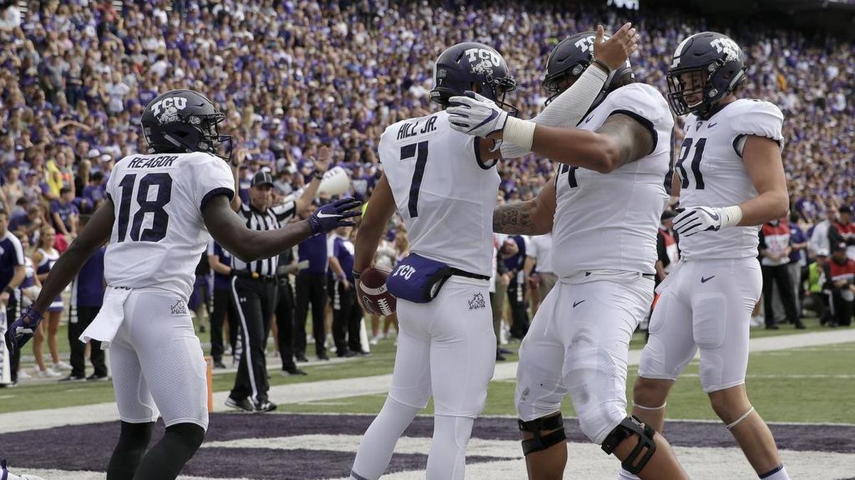 TCU quarterback Kenny Hill, middle, celebrates with teammates after running for a touchdown in the first hald of the Horned Frogs’ 26-6 win over Kansas State Saturday, Oct. 14, in Manhattan, Kan.