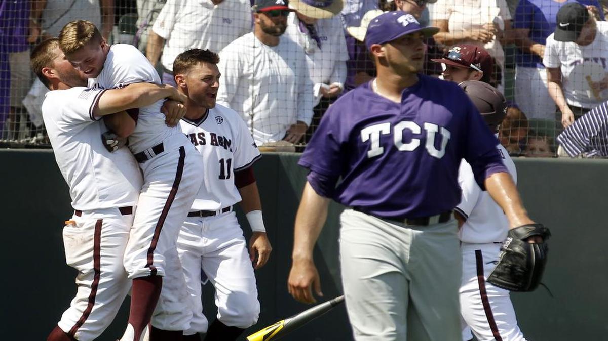 
Texas A&M celebrates a 2-1 win as TCU relief pitcher Riley Ferrell (12) walks away after game 2 of the NCAA Super Regional at Lupton Stadium Sunday, June 7, 2015.
