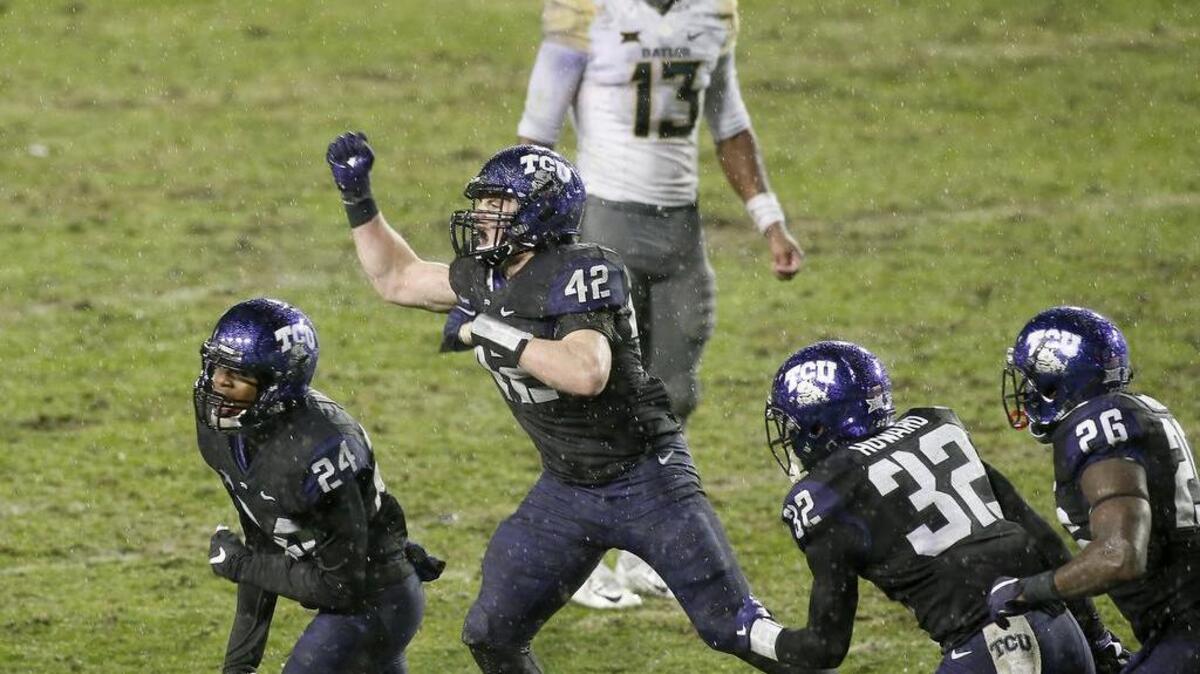 TCU linebacker Ty Summers (42) and cornerback Julius Lewis (24) react after the Horned Frogs stopped the Baylor Bears on a fourth-and-1 in the second overtime at Amon G. Carter Stadium on Friday. The Horned Frogs won 28-21 in double OT.