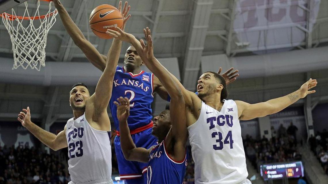 TCU Horned Frogs forward Ahmed Hamdy (23) and guard Kenrich Williams (34) as fight with Kansas Jayhawks guard Lagerald Vick (2) and guard Marcus Garrett (0) for a rebound in the first half the University of Kansas plays TCU in men's basketball at Schollmaier Arena in Fort Worth, Texas, Saturday, January 6, 2018.