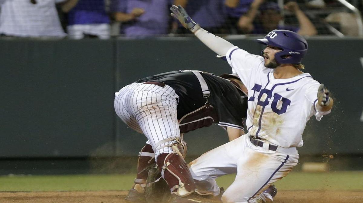 
TCU’s Garrett Crain slides in to score the winning run against Texas A&M and catcher Michael Barash. Crain forced a throw to the plate, and it got away, ending the game in the bottom of the 16th inning.
