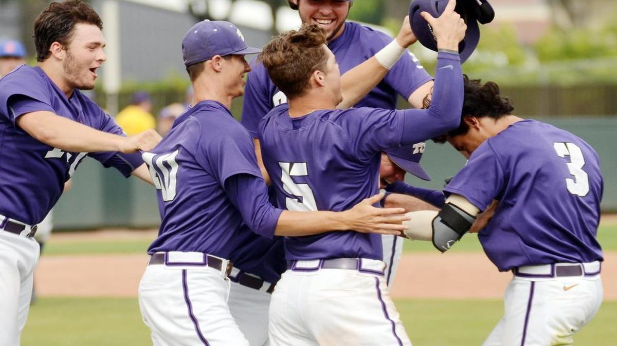 
TCU players swarm teammate Elliott Barzilli,  right, after he puts the ball in play to score a run off an error to give TCU the 2-1 win over Kansas in the 10th inning of Saturday at Lupton Stadium.
