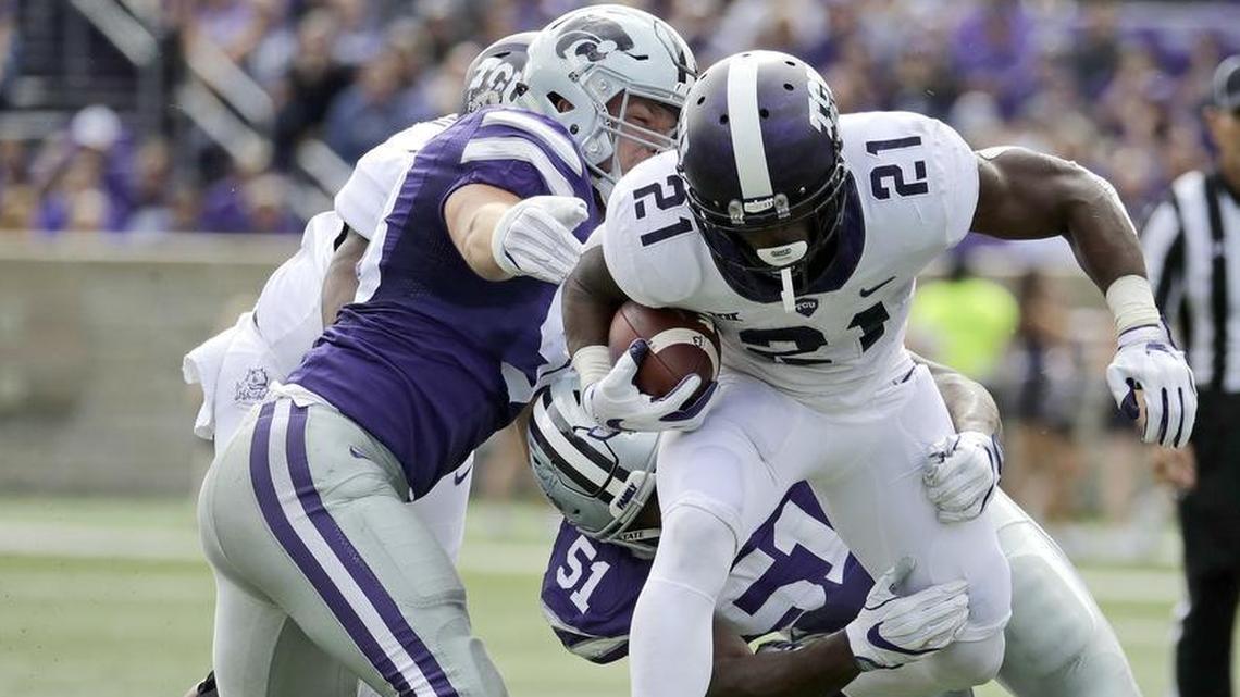 TCU running back Kyle Hicks gains ground attempting to break through Kansas State defenders during Saturday’s game at Bill Snyder Family Stadium in Manhattan, Kan.
