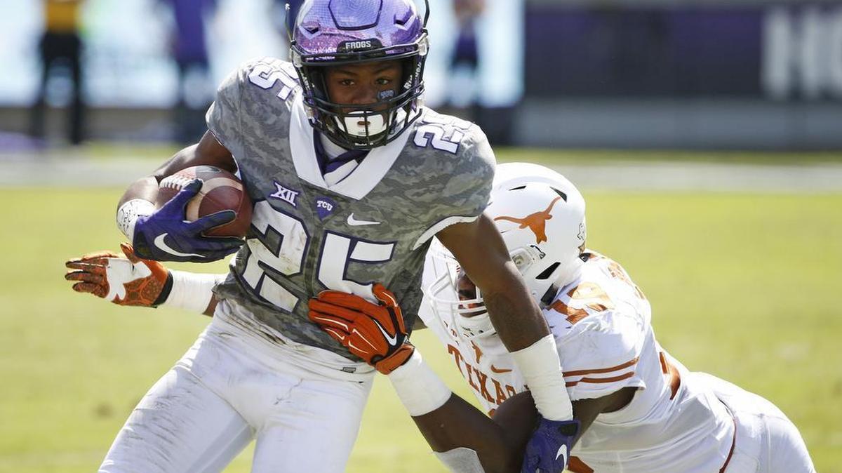 TCU receiver KaVontae Turpin makes a move to escape Texas linebacker Peter Jinkens during last season’s meeting at Amon G. Carter Stadium. Turpin caught four touchdown passes in the game, setting a record for a Big 12 freshman.