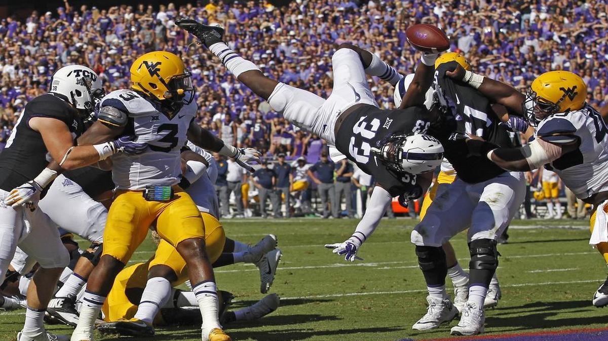 TCU running back Sewo Olonilua dives in for a second quarter touchdown during the Horned Frogs’ 31-24 win over West Virginia on Saturday, Oct. 7, at Amon G. Carter Stadium.