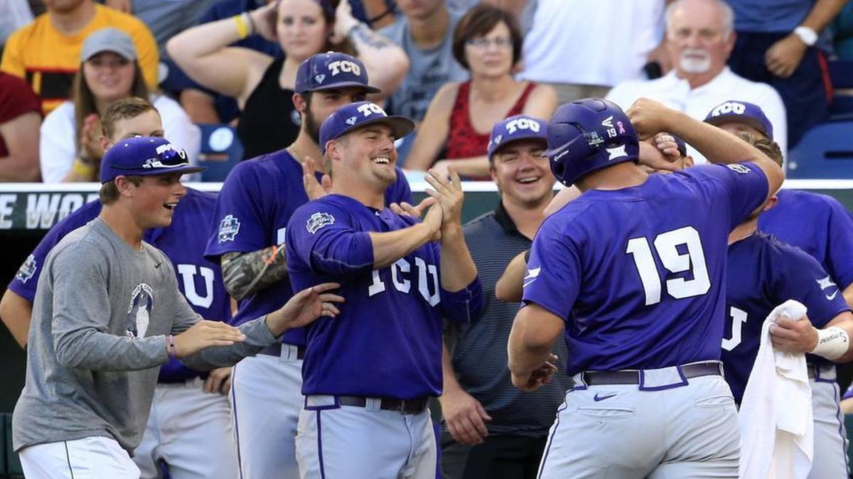 TCU’s Luken Baker (19) is welcomed home to a celebration of teammates after his second-inning home run put the Horned Frogs on the board first against Coastal Carolina. TCU won 6-1.