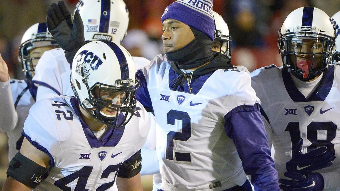 TCU quarterback Trevone Boykin (2) encourages teammates, including linebacker Ty Summers (42) and safety Nick Orr, in pregame Saturday night against Oklahoma. Boykin sat out with an injured ankle. Summers was ejected in the first half for targeting.