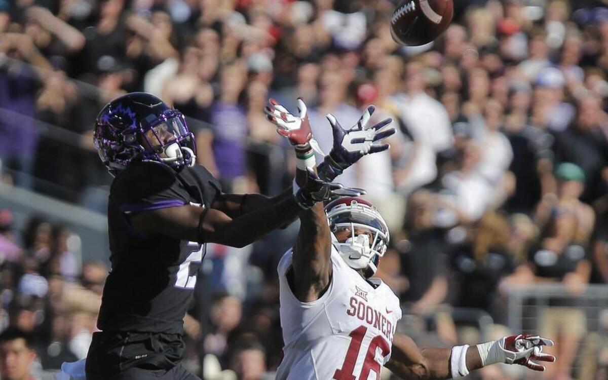 TCU receiver Taj Williams makes a move for a ball against the defense of Oklahoma cornerback Michiah Quick. The defender broke up the pass in the Sooners’ eventual 52-46 victory.