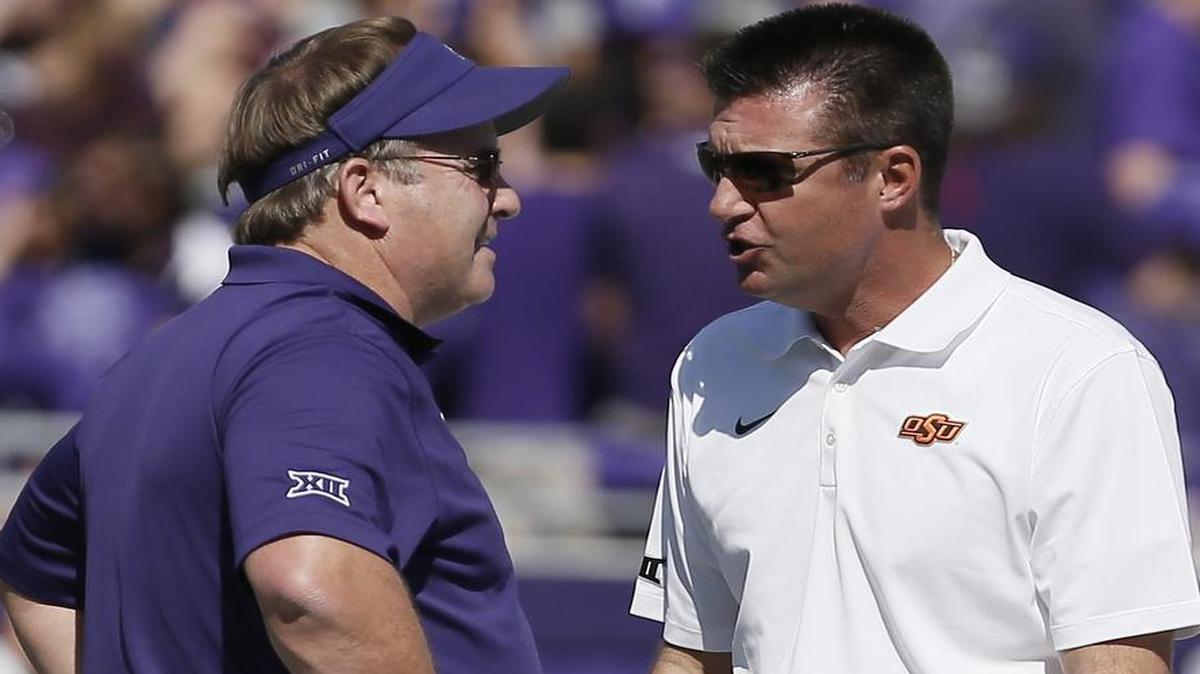 TCU coach Gary Patterson and Oklahoma State coach Mike Gundy talk on the field before an Oct. 18, 2014, game at Amon G. Carter Stadium.